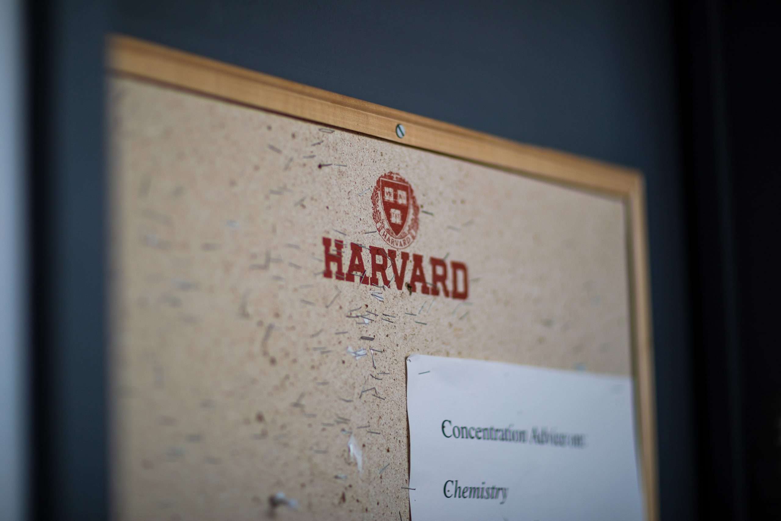 Harvard's logo is featured on a bulletin board.