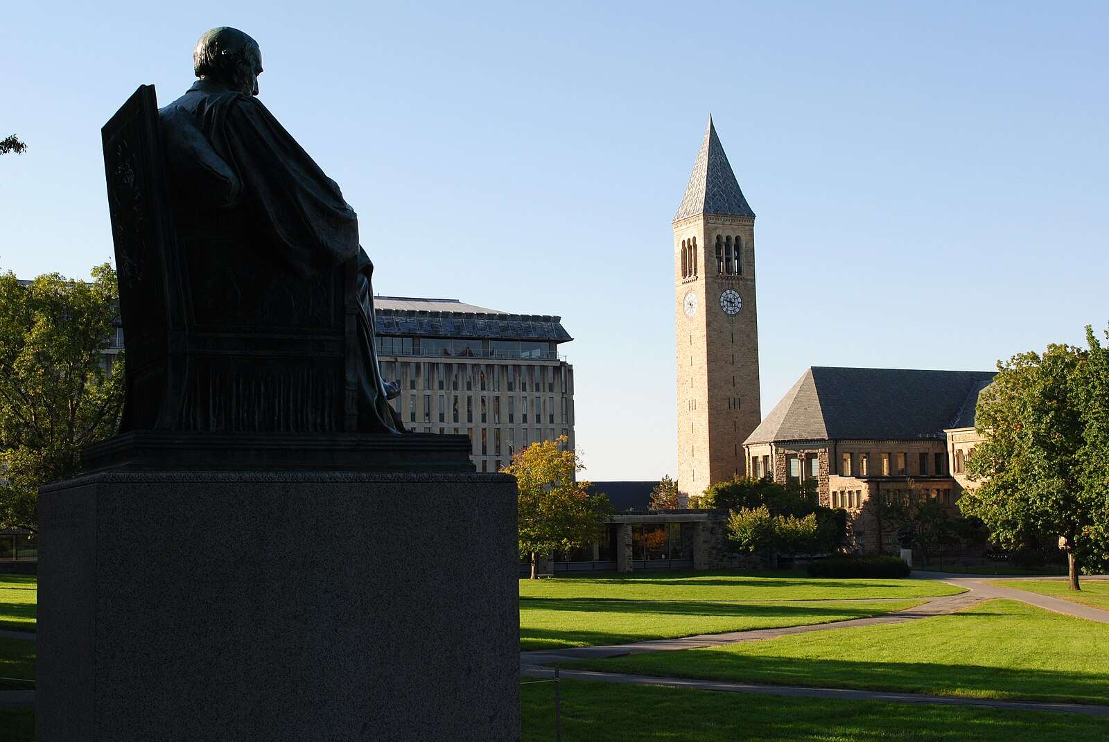 The arts quad is featured beyond a statue of Ezra Cornell at Cornell University.