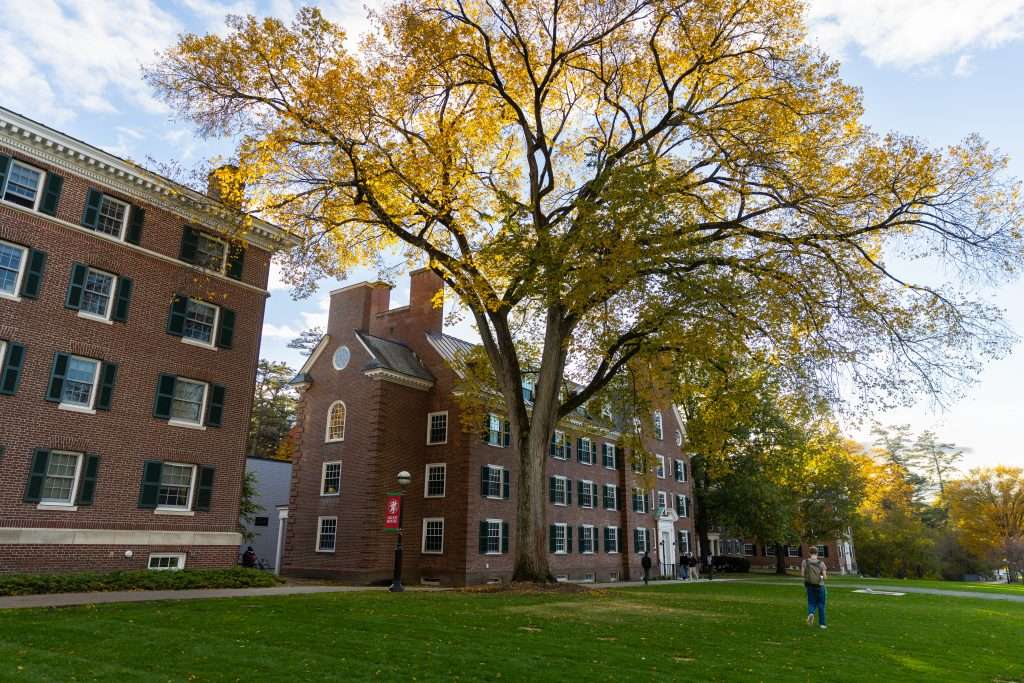 A student walks across The Green at Dartmouth College.