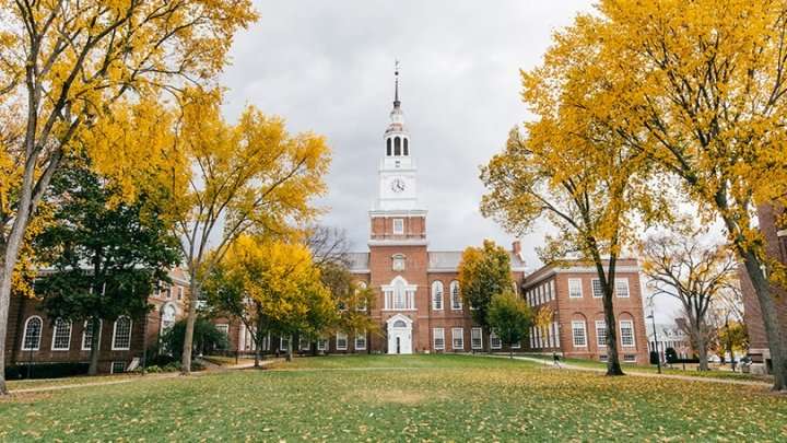 A colonial-style Dartmouth building is featured during the fall.