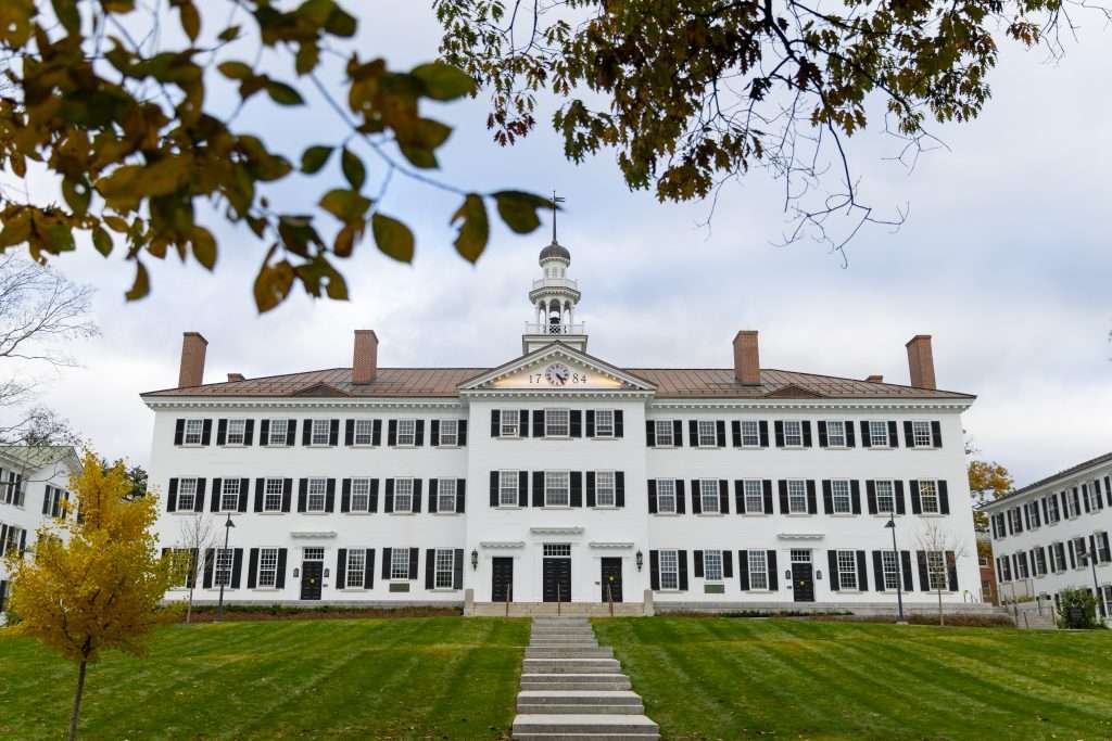 White-bricked Dartmouth Hall is featured beyond the Green of Dartmouth College.