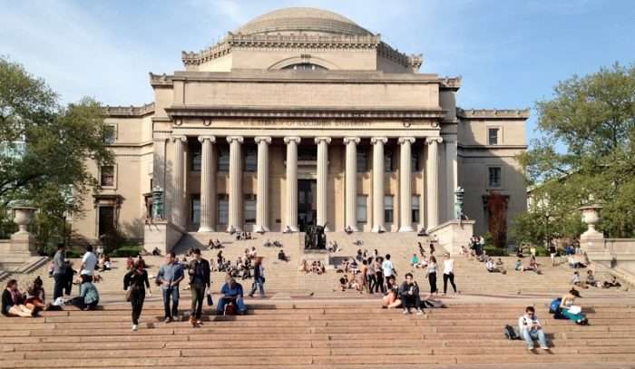 Columbia University library steps full of students sitting and walking