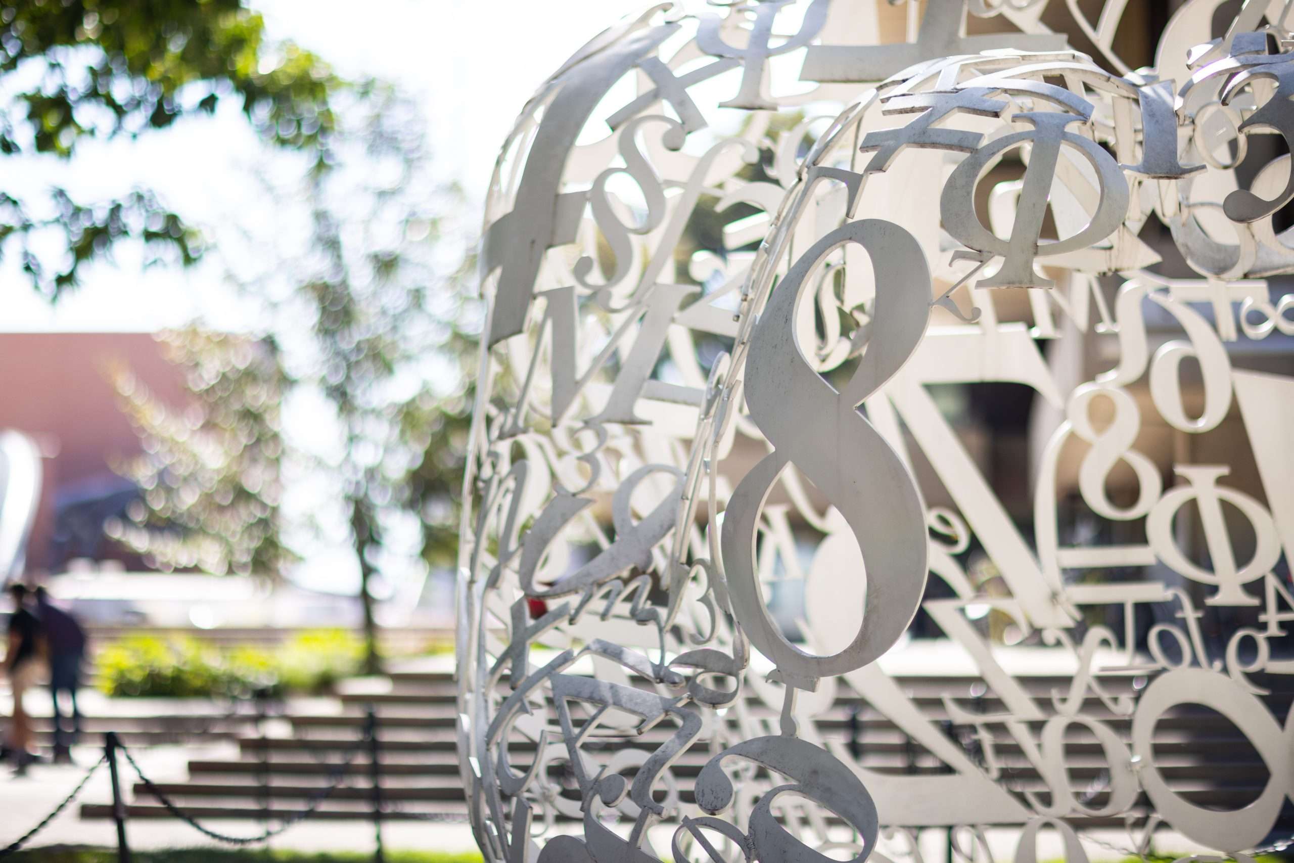 A circular art installation with numbers and mathematical symbols is featured at the Massachusetts Institute of Technology.