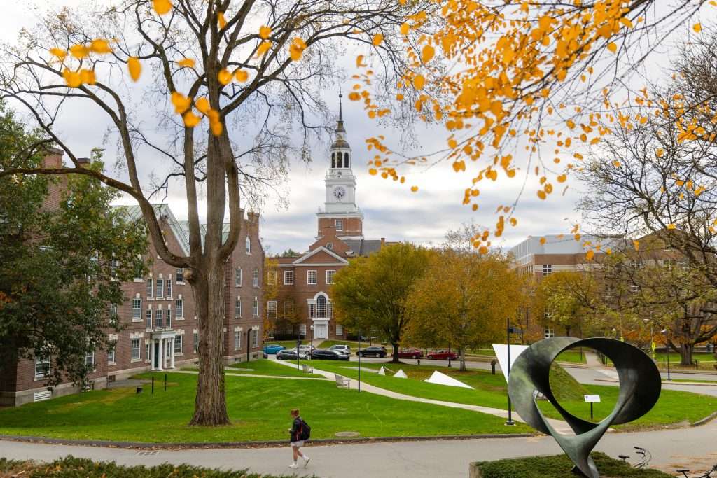 A student walks on a path in front of Baker Library at Dartmouth College.