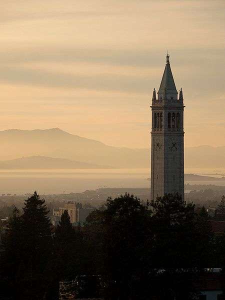 This is a wide shot of a college campus clock tower at dusk.