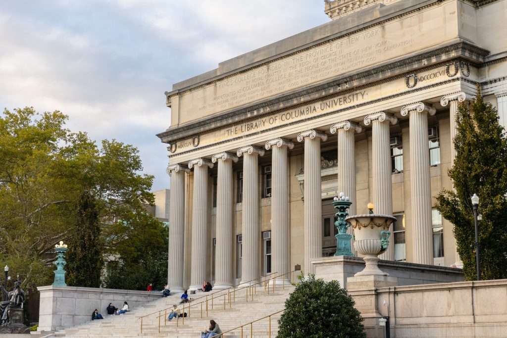 Students sit on the Low Library steps at Columbia University.