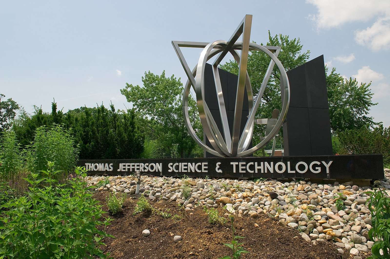 A metal sculpture and stone landscaping marks the entrance to Thomas Jefferson High School for Science & Technology.