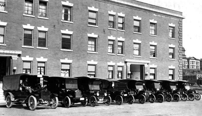 A black and white photo of old vehicles.