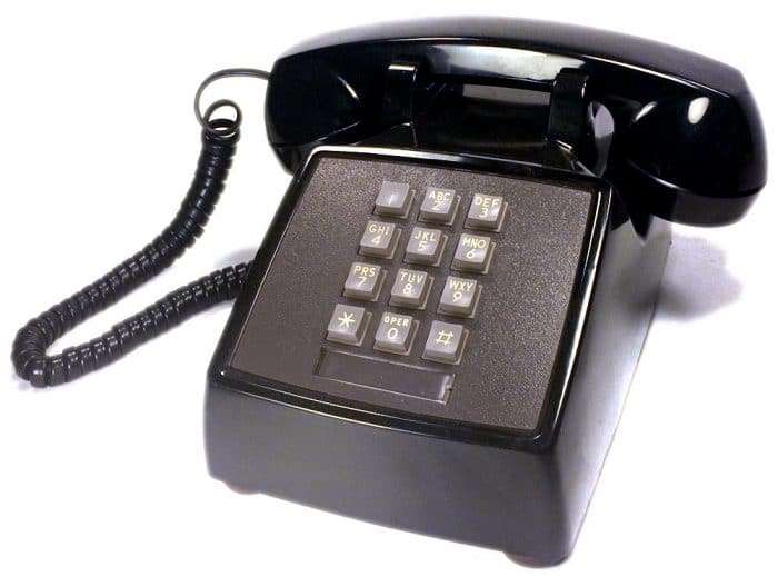 This is an old-fashioned black telephone with buttons to press.