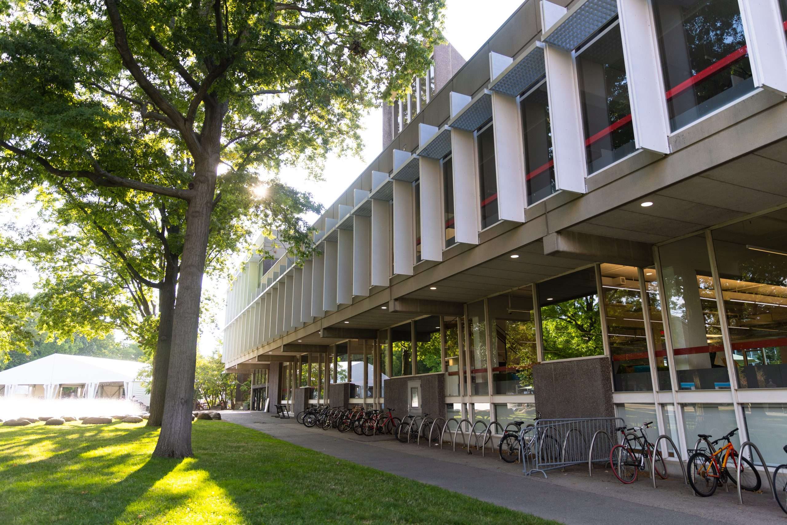 A bike rack sits outside a modernist building at Harvard University.